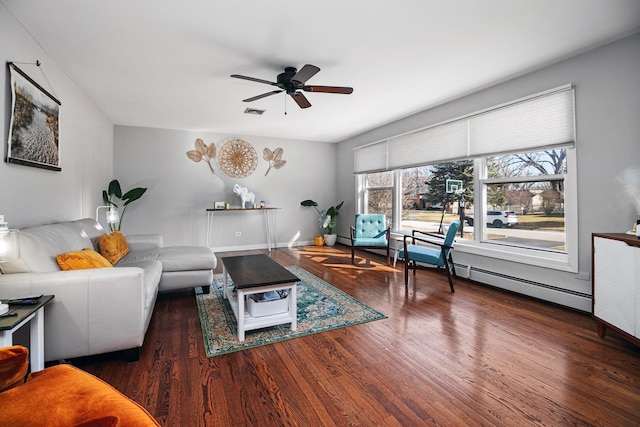 living room featuring visible vents, a ceiling fan, a baseboard heating unit, wood finished floors, and baseboards