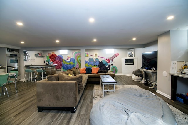 living room with recessed lighting, wood finished floors, and baseboards