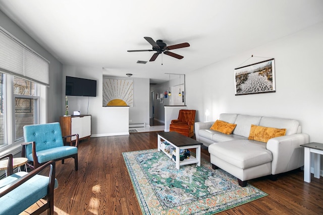 living area featuring baseboard heating, baseboards, ceiling fan, and wood finished floors