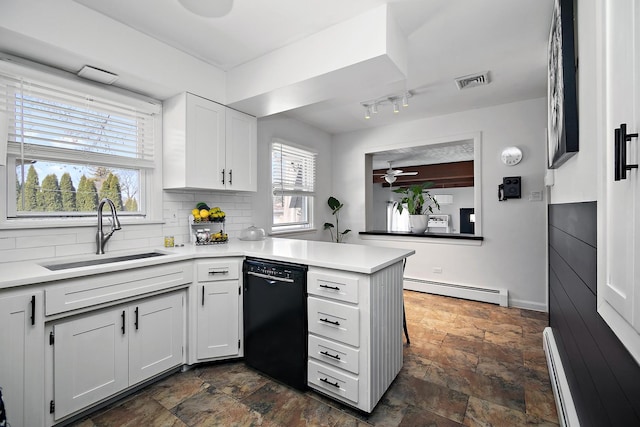 kitchen featuring a baseboard heating unit, a peninsula, black dishwasher, and a sink