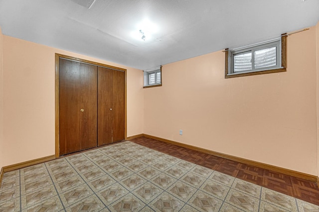 unfurnished bedroom with baseboards and a closet