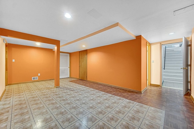 finished basement featuring recessed lighting, visible vents, and baseboards