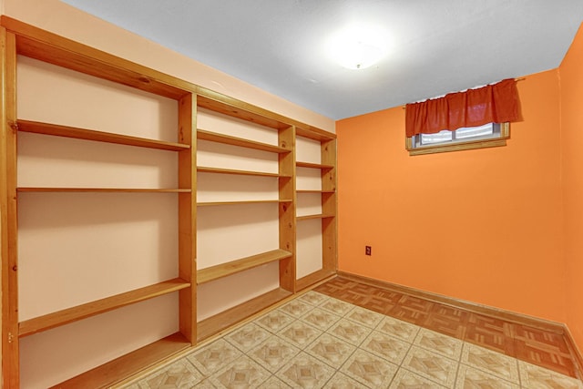 empty room featuring light floors and baseboards