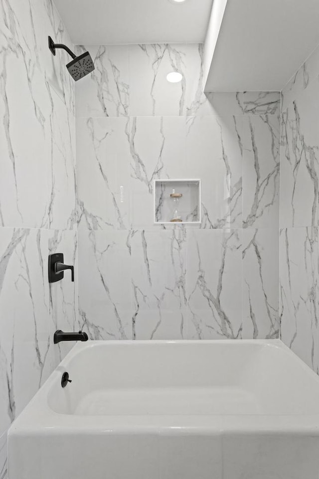 full bathroom featuring stone wall