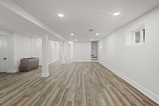 basement featuring recessed lighting, visible vents, stairway, light wood-style flooring, and baseboards