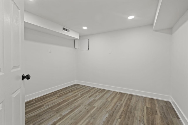 finished basement featuring recessed lighting, wood finished floors, visible vents, and baseboards