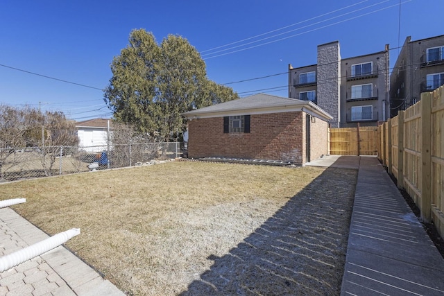 view of yard with a fenced backyard and an outdoor structure