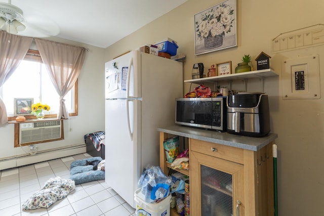 kitchen with open shelves, stainless steel microwave, tile patterned floors, and freestanding refrigerator