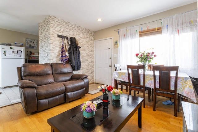 living area featuring light wood-style flooring and recessed lighting