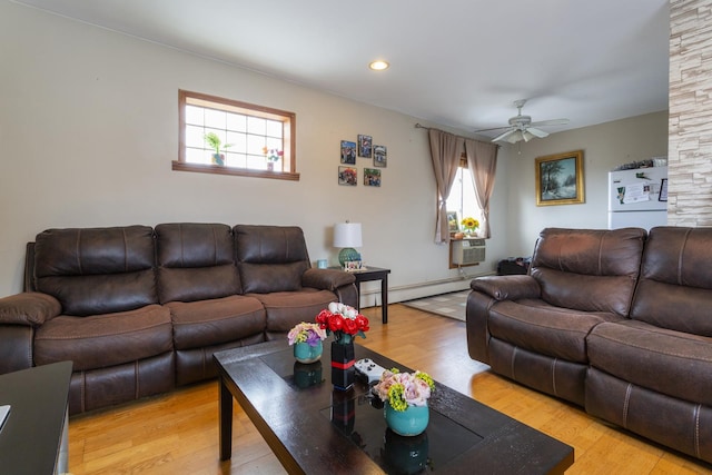 living room featuring recessed lighting, light wood-style floors, baseboard heating, and ceiling fan