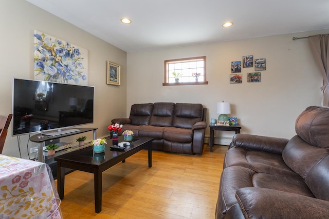 living area with recessed lighting, light wood-type flooring, and a baseboard heating unit