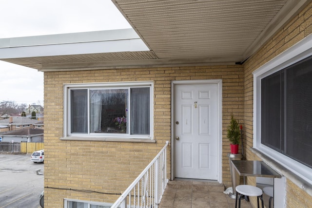 entrance to property featuring brick siding