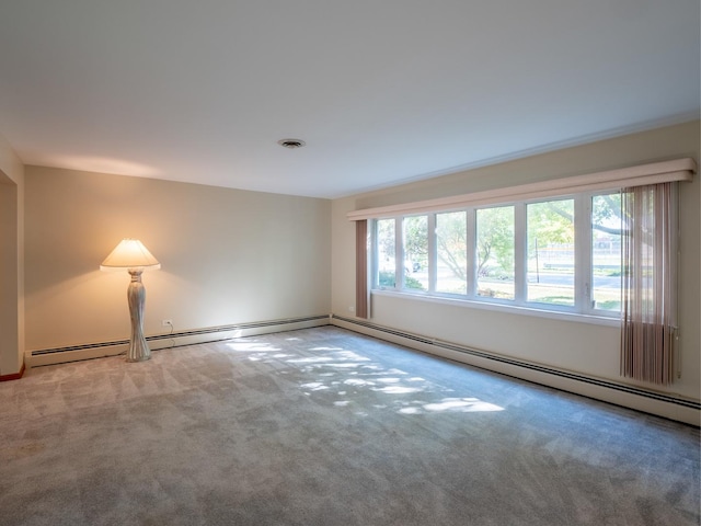 carpeted spare room with a baseboard radiator and visible vents