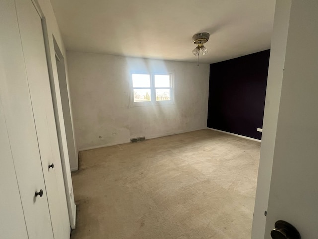 unfurnished bedroom featuring visible vents and carpet flooring