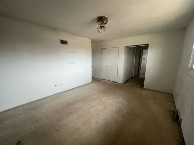 unfurnished bedroom with visible vents and two closets