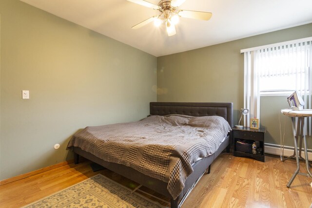 bedroom featuring a ceiling fan and wood finished floors