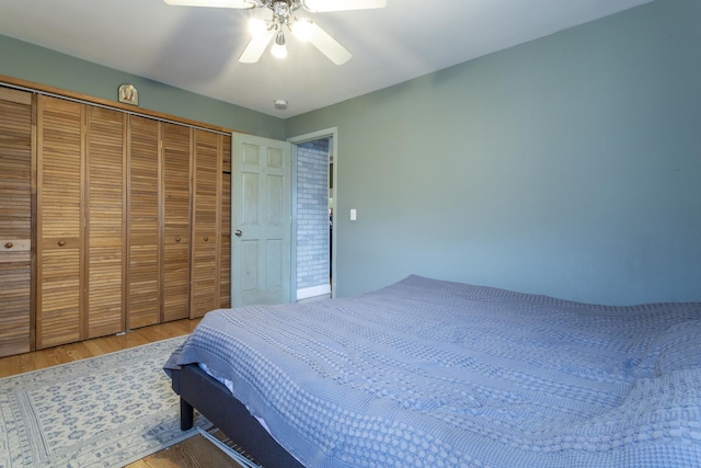 bedroom with wood finished floors, a closet, and ceiling fan