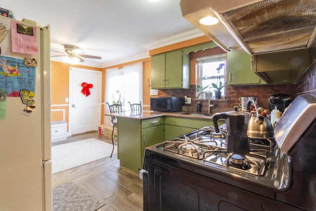 kitchen featuring black appliances, crown molding, backsplash, and green cabinetry