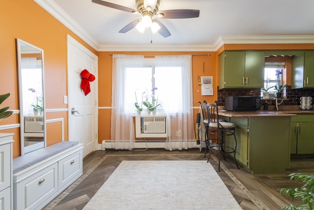 kitchen with ornamental molding, an AC wall unit, black microwave, and green cabinetry