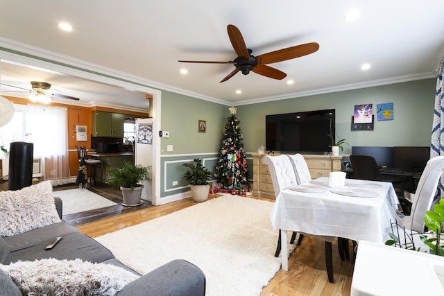 living room featuring recessed lighting, light wood-style flooring, and ornamental molding