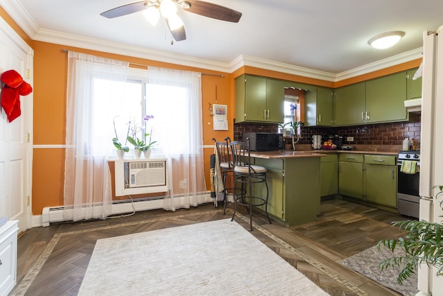 kitchen featuring green cabinets, black microwave, under cabinet range hood, stainless steel range with gas stovetop, and baseboard heating