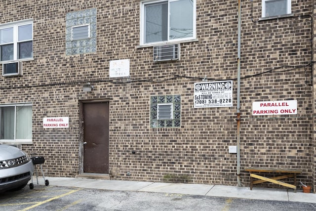 view of building exterior with uncovered parking