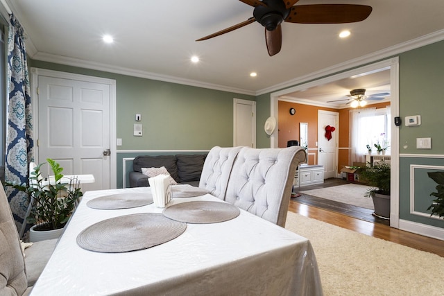 dining room featuring recessed lighting, wood finished floors, and ornamental molding