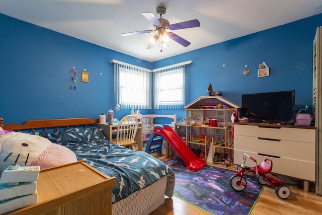 bedroom featuring wood finished floors and a ceiling fan