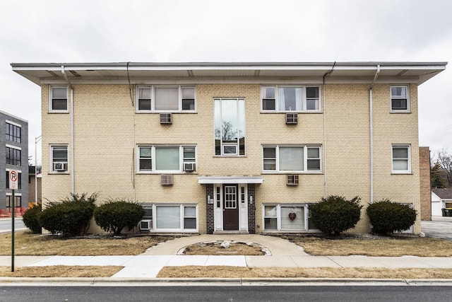 view of building exterior with a wall mounted AC