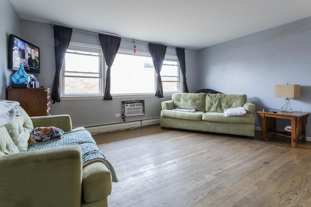 living area featuring an AC wall unit, a wealth of natural light, wood finished floors, and baseboard heating