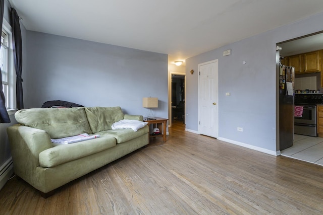 living area with light wood finished floors and baseboards