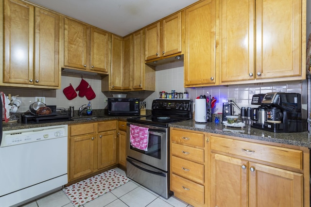 kitchen featuring black microwave, stainless steel electric stove, decorative backsplash, white dishwasher, and a sink