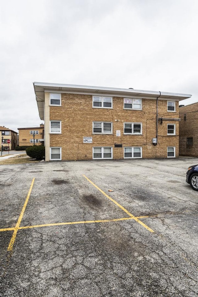 view of property featuring uncovered parking