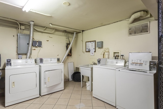 clothes washing area featuring light tile patterned floors, visible vents, electric panel, and separate washer and dryer