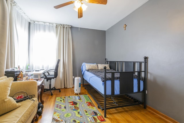 bedroom with a ceiling fan and wood finished floors