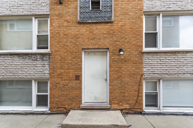 entrance to property with brick siding