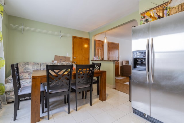 dining space featuring light tile patterned flooring