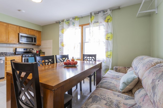 dining space featuring light tile patterned flooring