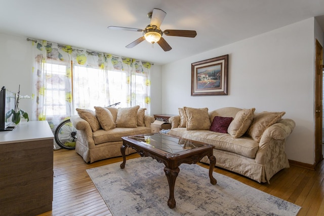 living room featuring light wood-style floors and a ceiling fan