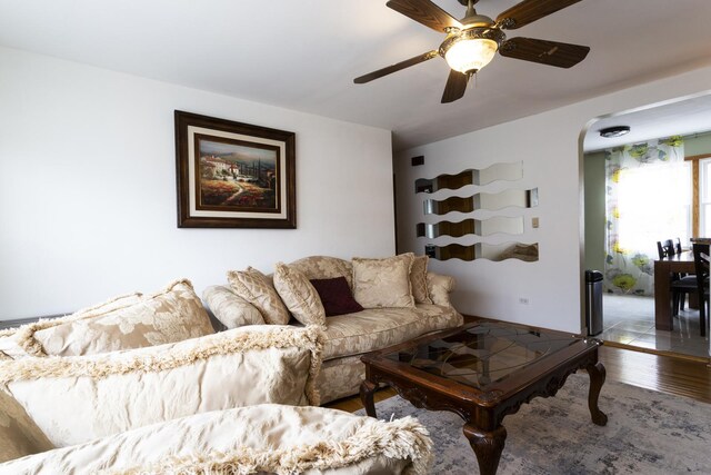 living room with ceiling fan and wood finished floors