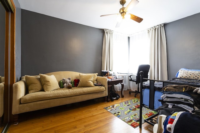 bedroom with wood finished floors and a ceiling fan