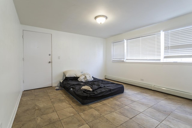 unfurnished room featuring baseboards and a baseboard radiator