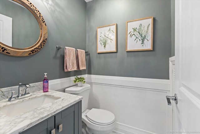 half bathroom featuring toilet and vanity