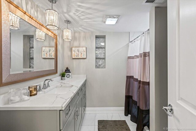 full bath featuring marble finish floor, vanity, a shower with shower curtain, and baseboards