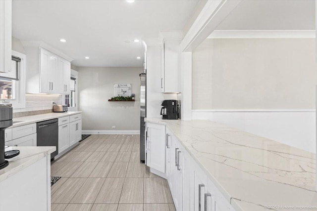 kitchen with backsplash, recessed lighting, white cabinets, light stone countertops, and dishwasher