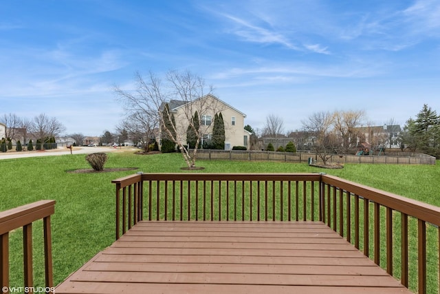 wooden terrace with a yard and fence