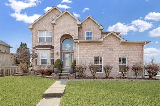 26800 Basswood Cir, Plainfield, IL 60585 - traditional-style home with brick siding, a front yard, and fence