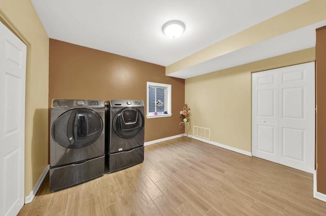 26800 Basswood Cir, Plainfield, IL 60585 - laundry room with visible vents, washer and dryer, light wood finished floors, baseboards, and laundry area