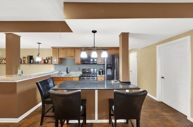 26800 Basswood Cir, Plainfield, IL 60585 - kitchen with a sink, a kitchen breakfast bar, backsplash, stainless steel appliances, and hanging light fixtures