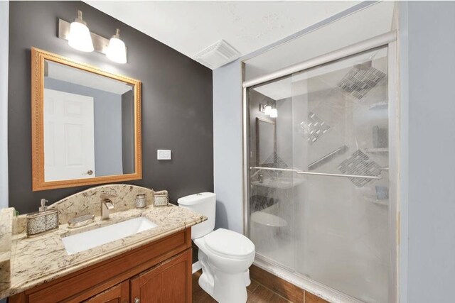 26800 Basswood Cir, Plainfield, IL 60585 - bathroom with visible vents, a shower stall, toilet, and vanity